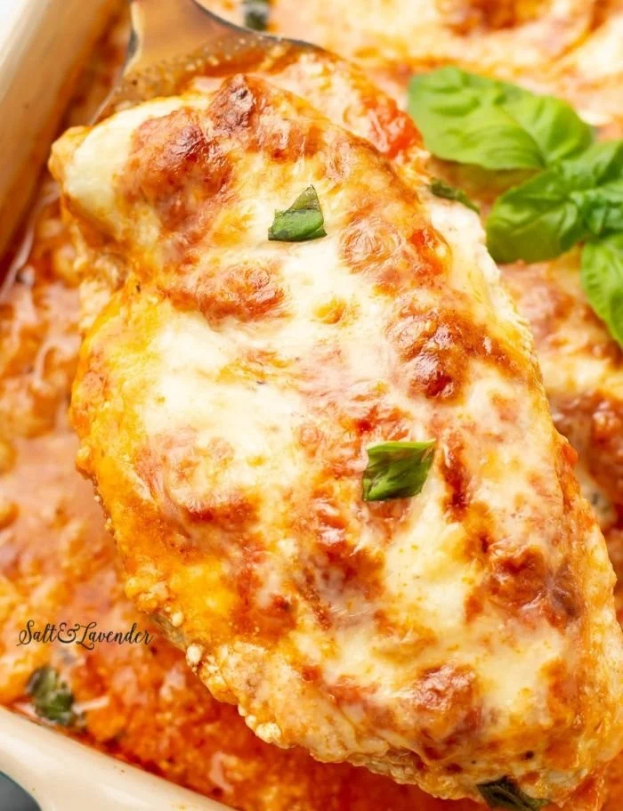 Baked Ricotta Chicken topped with herbs and served on a plate