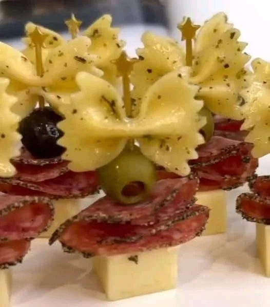 Bow tie pasta appetizers arranged on a platter, garnished and ready to serve.
