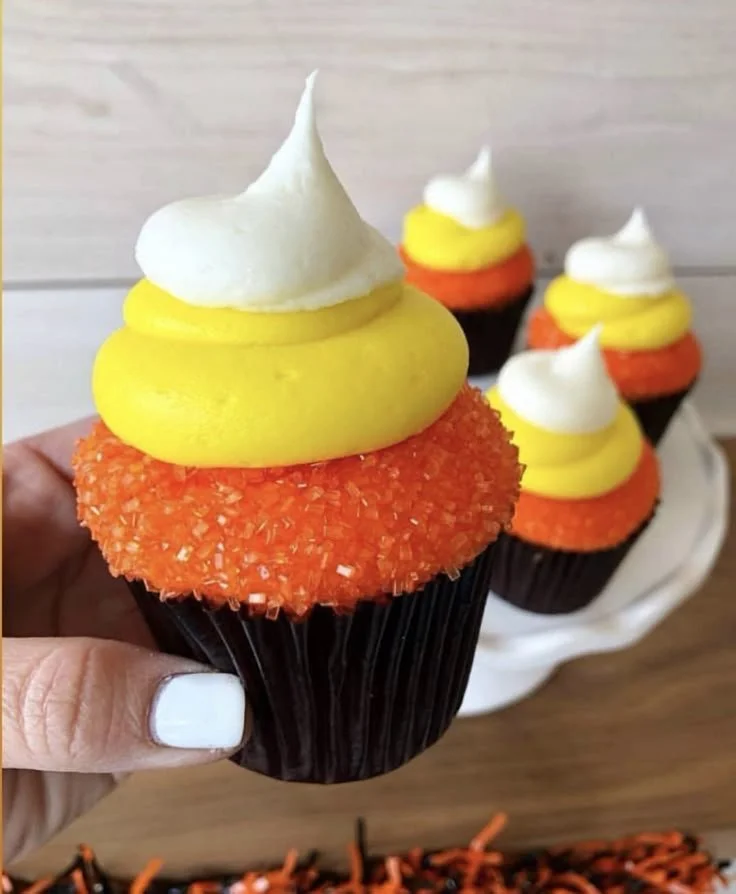 Colorful candy corn cupcakes topped with buttercream frosting