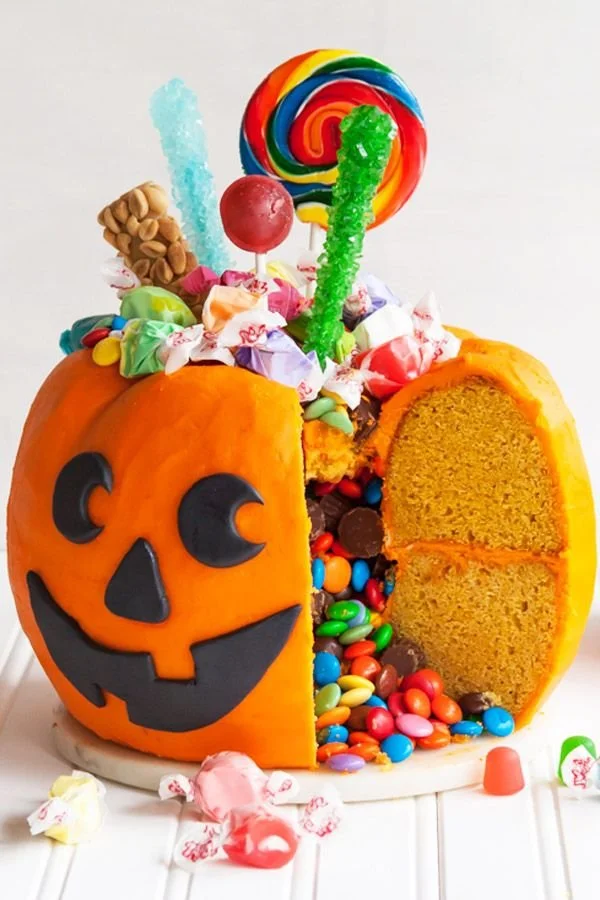 Candy-filled pumpkin pail cake decorated for Halloween