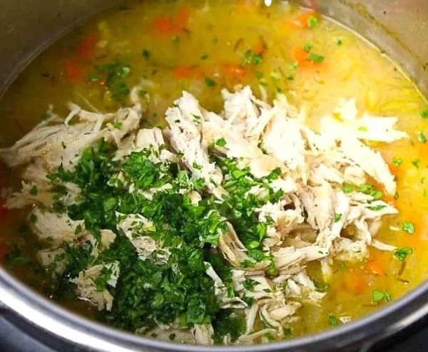 Delicious Chicken Rice Soup served in a bowl with fresh herbs