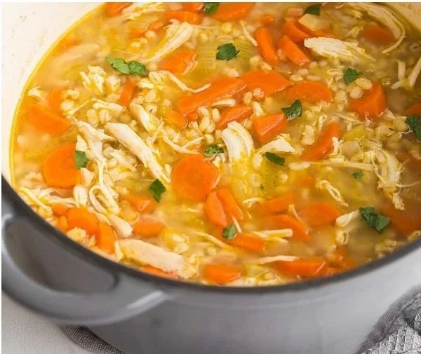 A bowl of hearty Chicken Barley Soup with fresh herbs and vegetables.