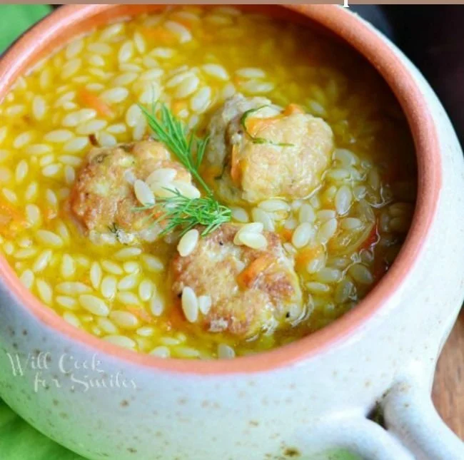 Bowl of Chicken Meatball Soup with orzo and fresh herbs