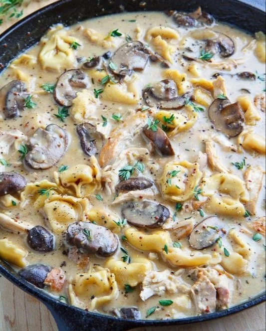 Creamy Asiago chicken and mushroom tortellini soup in a bowl
