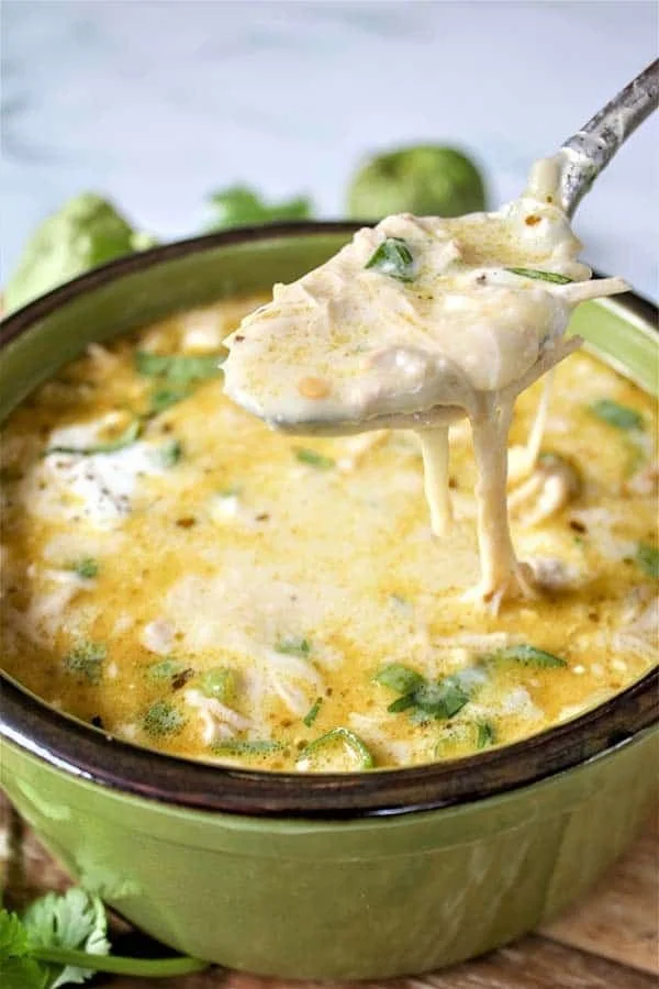Creamy green enchiladas chicken soup with fresh ingredients and garnishes