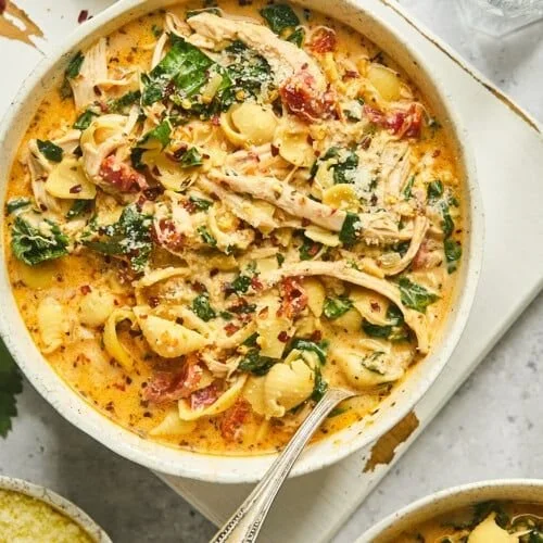 Bowl of creamy Marry Me Chicken soup garnished with herbs