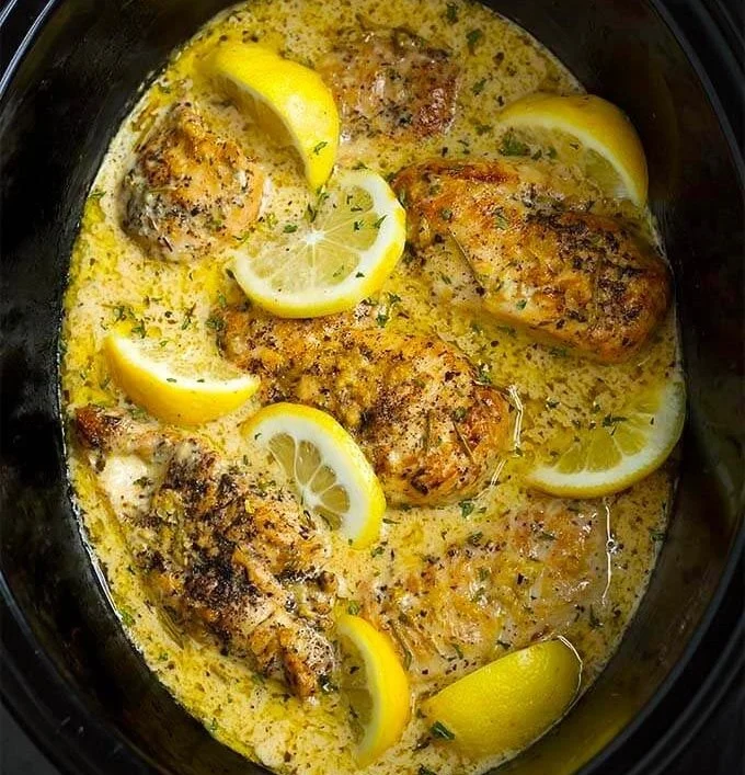 Crock Pot creamy lemon chicken breasts served on a rustic plate