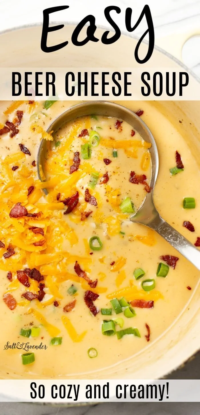 Bowl of easy beer cheese soup topped with herbs and bread
