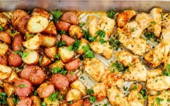 Garlic Parmesan Chicken with crispy potatoes on a plate.
