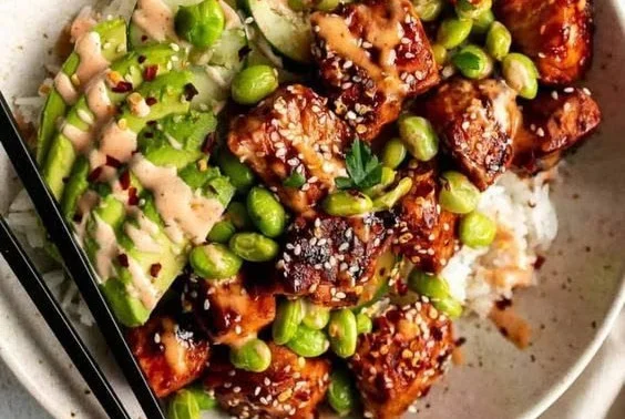 Honey Sriracha Salmon Bowl garnished with fresh vegetables and rice
