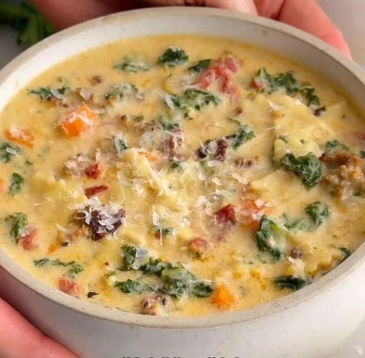 Bowl of Italian Sausage Pasta Soup garnished with herbs and vegetables