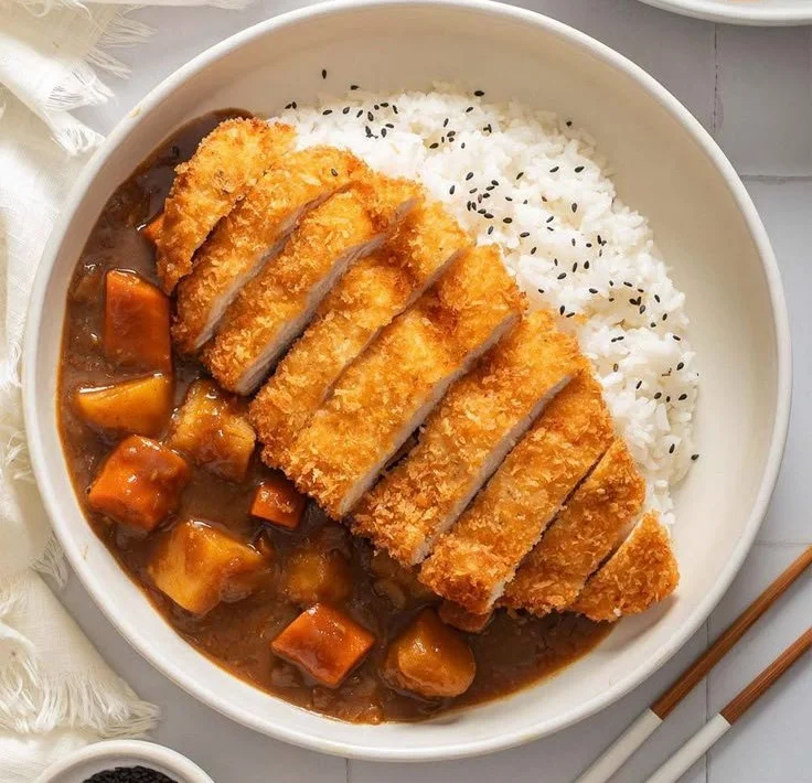 Delicious Japanese Chicken Katsu Curry served with rice and vegetables
