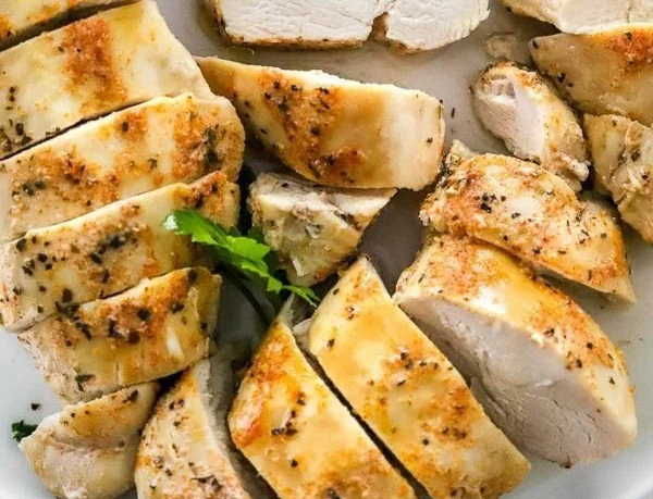 Juicy slow cooker chicken breast served with vegetables and herbs