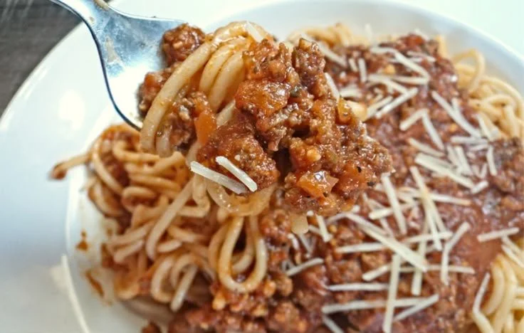 Low sodium meaty spaghetti sauce in a bowl with fresh herbs