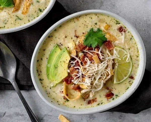 Bowl of Mexican Street Corn White Chicken Chili topped with fresh cilantro and cheese.