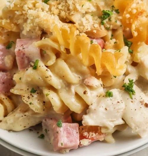 One-Pot Chicken Cordon Bleu Casserole topped with cheese and herbs