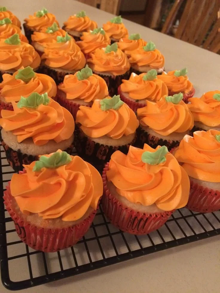 Delicious pumpkin cupcakes topped with cream cheese frosting and fall spices.