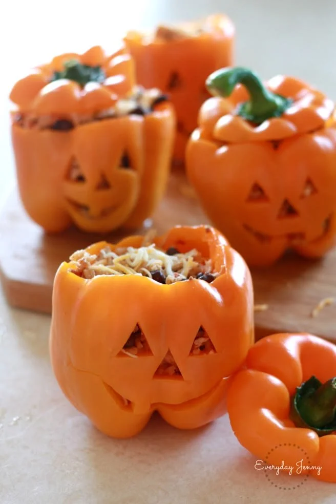Halloween themed stuffed peppers with shredded chicken and rice.