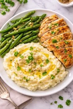 Bowl of creamy mashed celery potatoes topped with fresh herbs