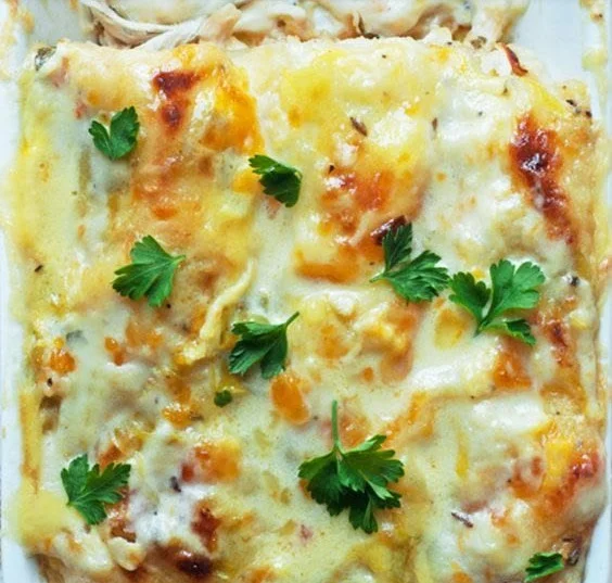 Skinny white chicken enchiladas served on a plate with toppings