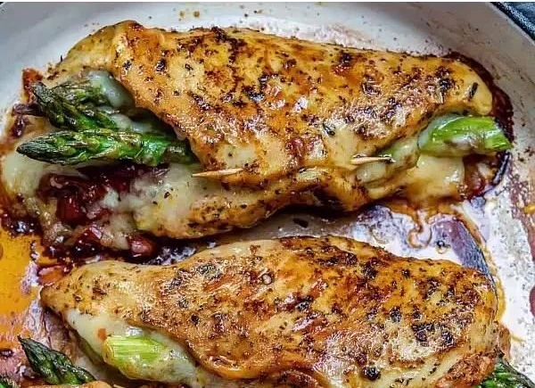 Savory stuffed chicken breasts ready to be served on a plate.