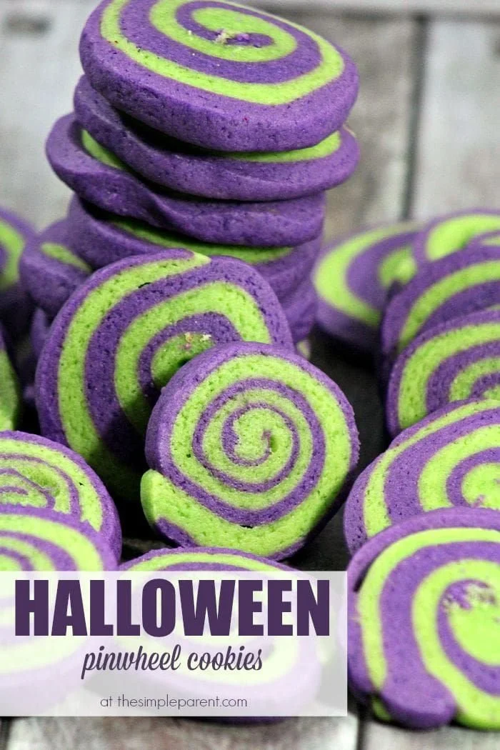 Colorful Halloween pinwheel cookies arranged on a festive platter.