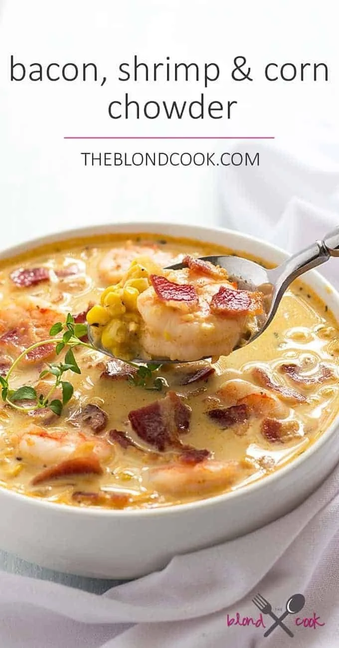Bacon, shrimp, and corn chowder garnished with herbs in a bowl