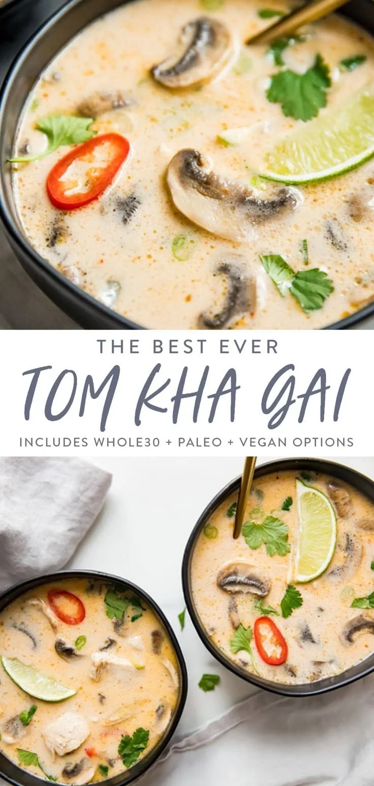 Bowl of Tom Kha Gai soup with chicken and coconut milk, garnished with herbs.