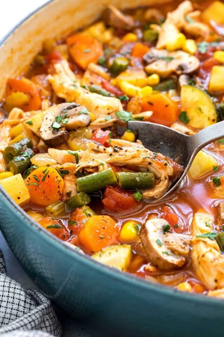 A bowl of hearty Chicken Vegetable Soup filled with colorful vegetables and chicken.