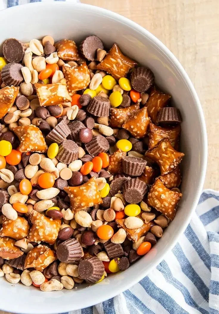 A bowl of Chocolate Peanut Butter Trail Mix with nuts and chocolate pieces