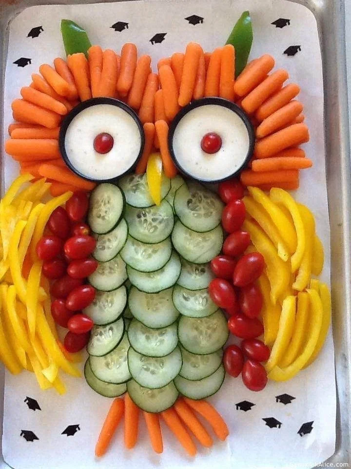 Colorful and healthy owl veggie plate decorated with fresh vegetables and fruits.