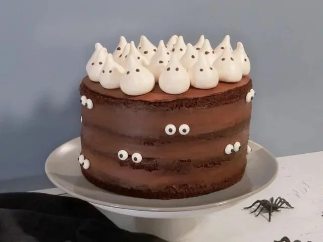 Spooky Halloween party desserts including cupcakes, cookies, and treats.