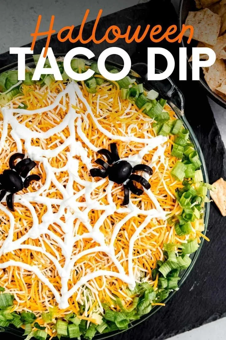 Halloween Taco Dip recipe served in a festive dish with spooky toppings