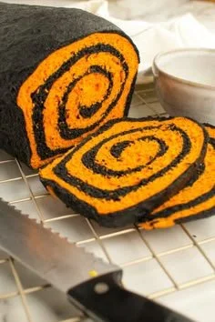 A loaf of Halloween bread decorated with spooky icing and festive toppings.