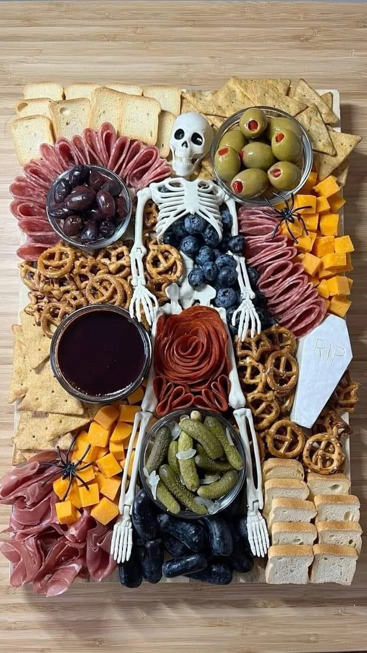 A creative Halloween Charcuterie Board filled with spooky-themed snacks.