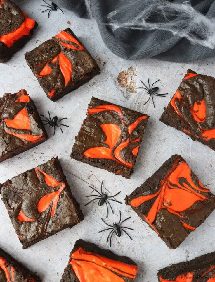 Delicious Halloween cheesecake brownies topped with spooky decorations