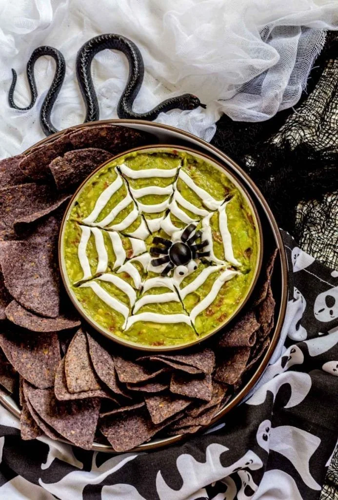 Halloween guacamole spiderweb appetizers for a spooky party
