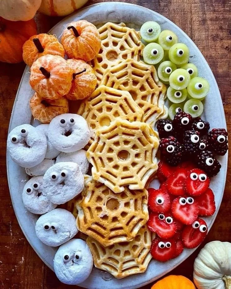 Colorful Halloween breakfast platter with candy edible eyes for kids party.