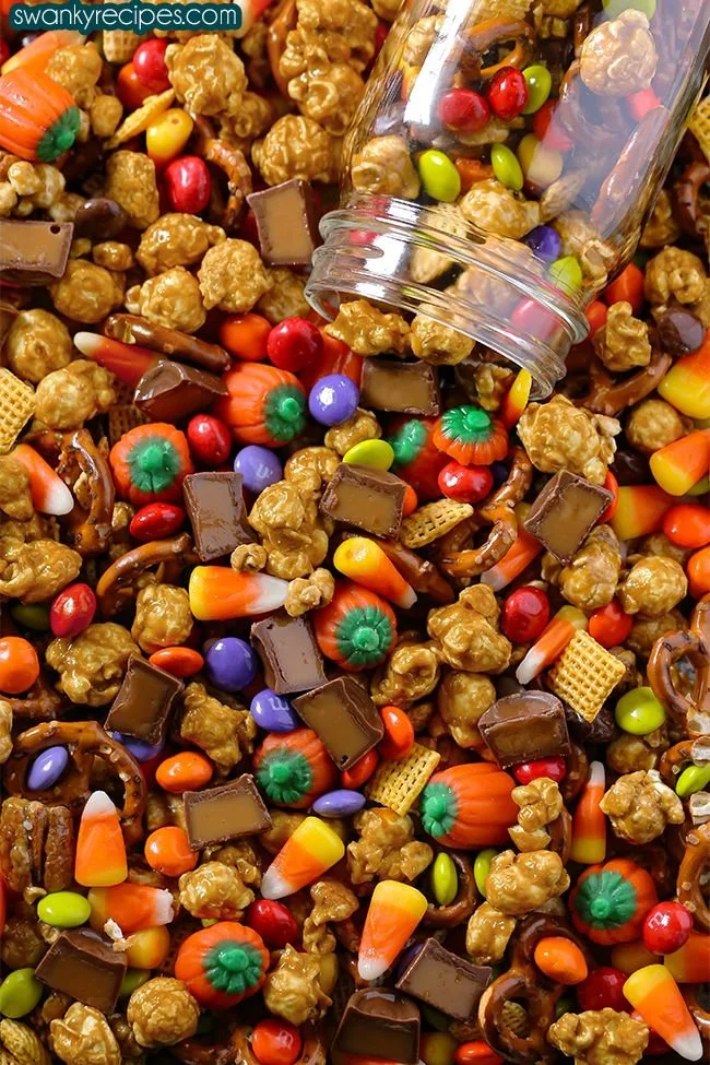 Bowl of Halloween Munch Chex Mix with festive candy decorations