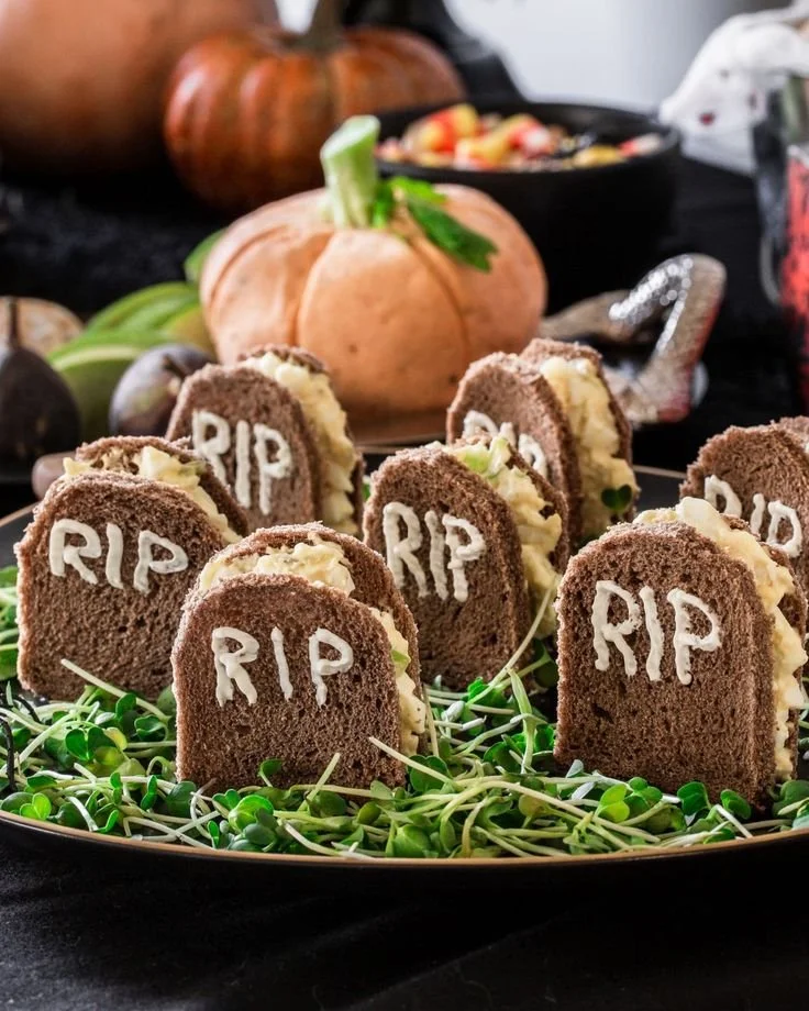 Assorted Halloween themed sandwiches arranged on a platter for festive treats.
