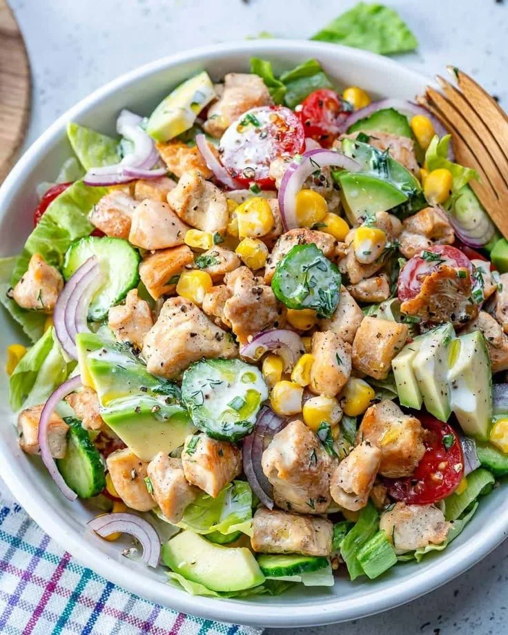 Bowl of healthy ranch chicken salad with fresh ingredients and dressing