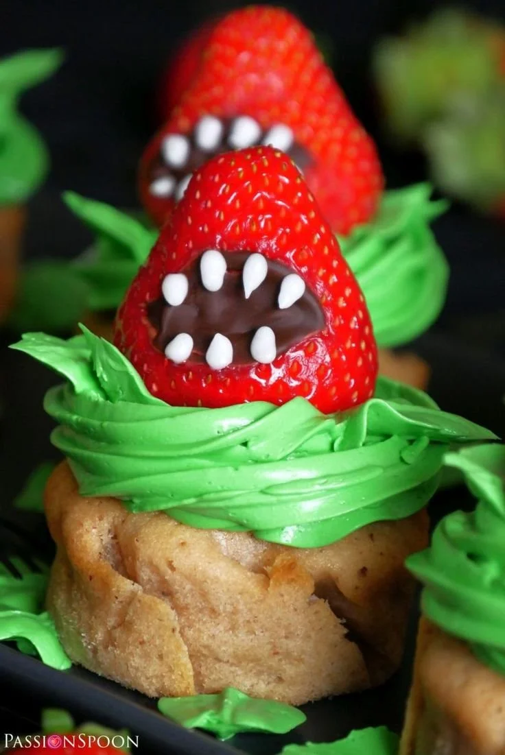 Monster strawberry cupcakes topped with colorful frosting and playful decorations