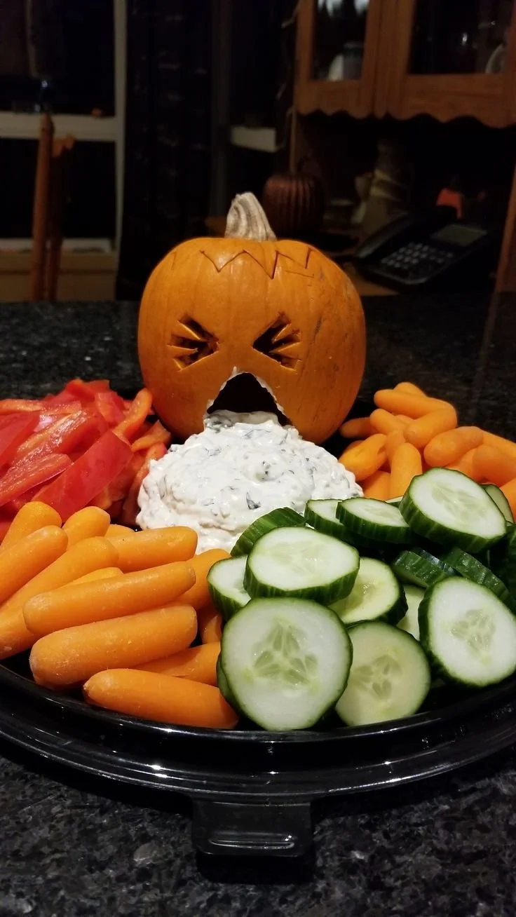 Colorful Puking Pumpkin veggie tray for Halloween parties.