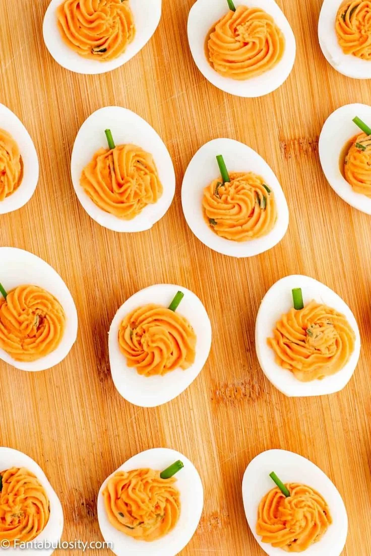 Pumpkin Deviled Eggs served on a platter, ideal for Halloween and Thanksgiving parties.