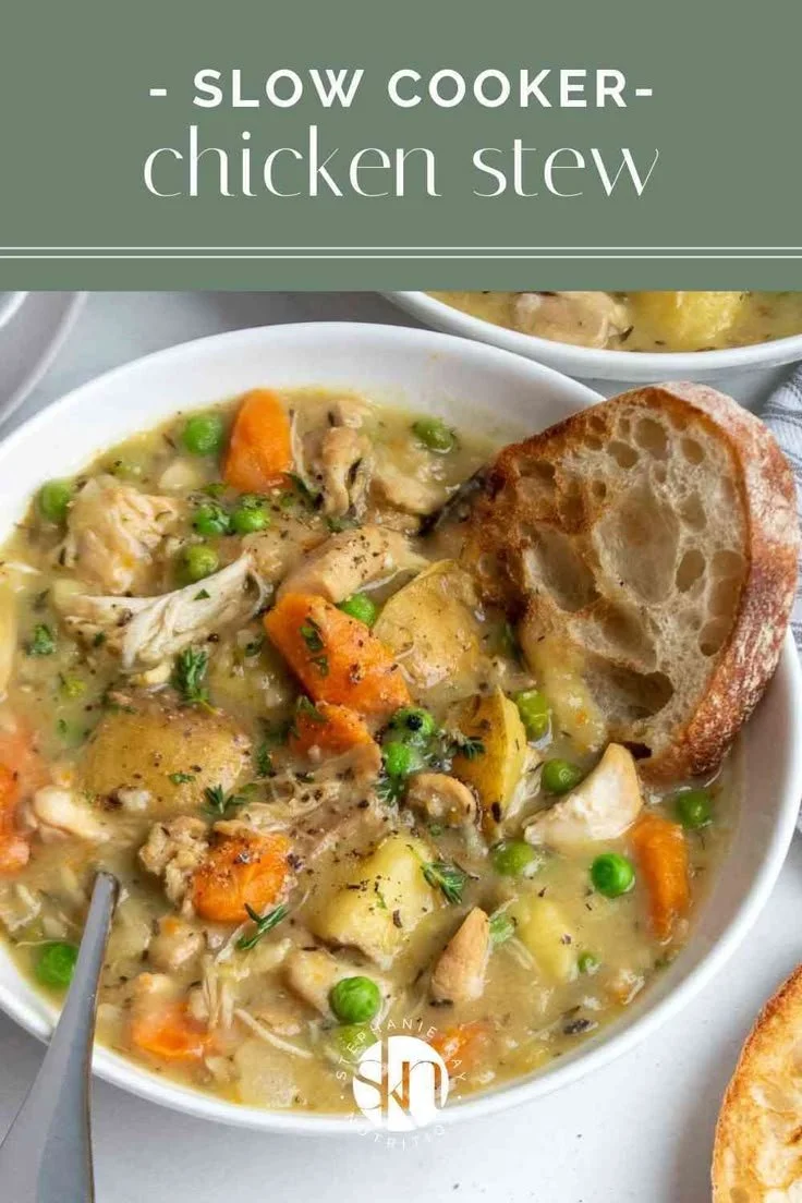 Bowl of slow cooker chicken stew with vegetables and herbs