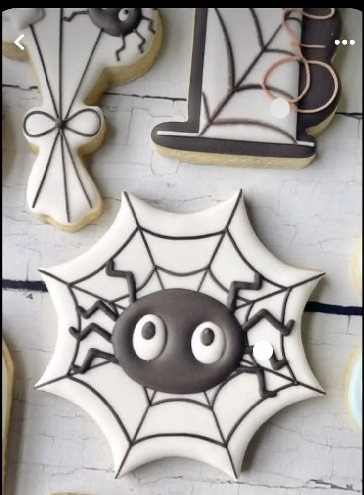 Spooky spiderweb Halloween sugar cookies decorated with bats and spiders